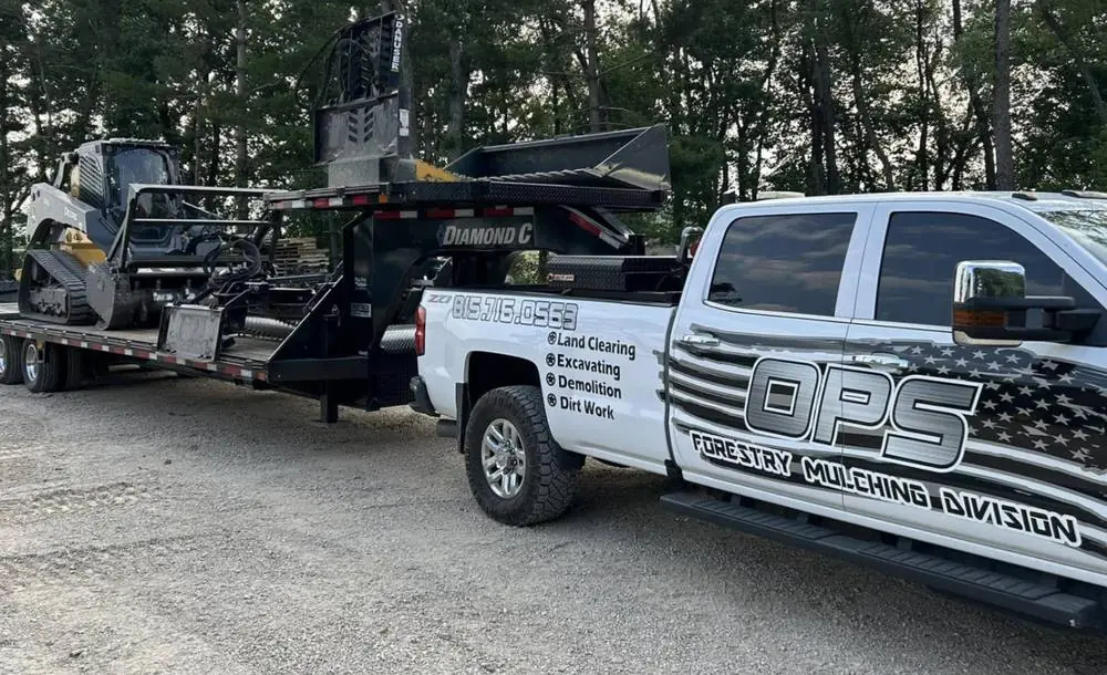 OPS Forestry Mulching Division truck and loaded equipment trailer